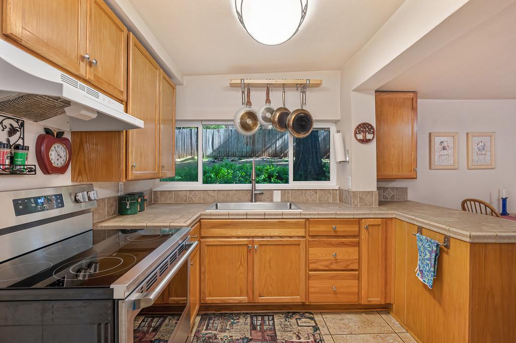 6252 Pony Express Trail Pollock Pines, CA 95726 - Photo 19 of 43 a kitchen with stainless steel appliances granite countertop a sink and a stove