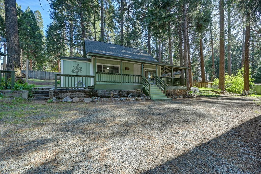 6252 Pony Express Trail Pollock Pines, CA 95726 - Photo 2 of 43 a view of a house with a yard and trees