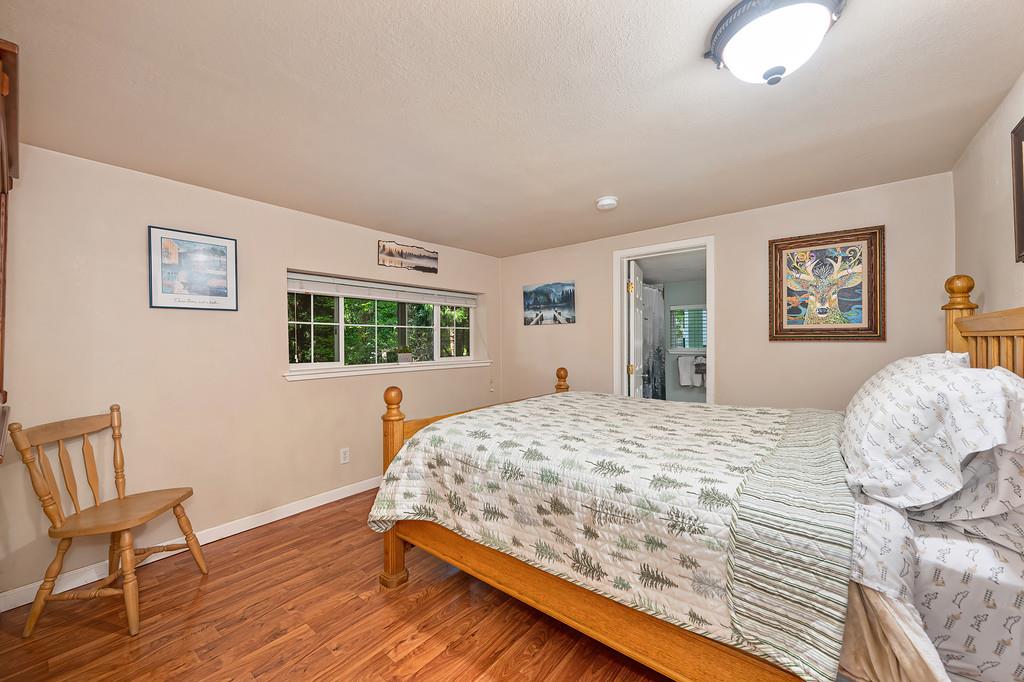 6252 Pony Express Trail Pollock Pines, CA 95726 - Photo 27 of 43 a bedroom with a bed and a chair