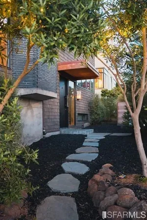 a front view of a house with garden