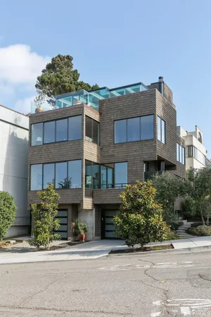 a bedroom with a bed and a dresser next to a window