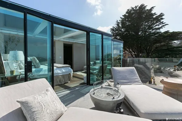 a view of a hallway with wooden floor and glass door