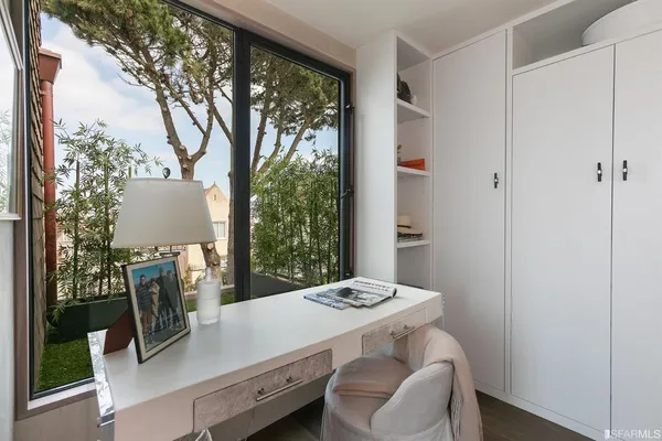 a living room with furniture and a floor to ceiling window