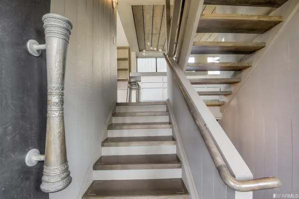 a dining hall with stainless steel appliances granite countertop a stove and a sink