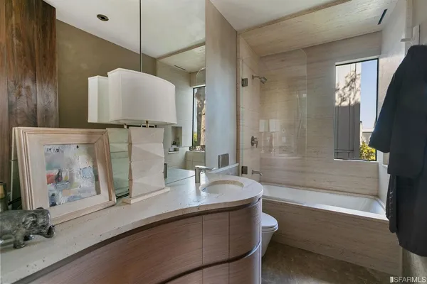 a bathroom with a sink a vanity and a large mirror