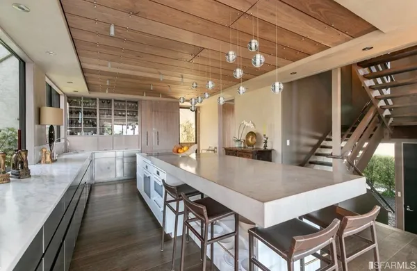 a large pool table in a living room with a large window