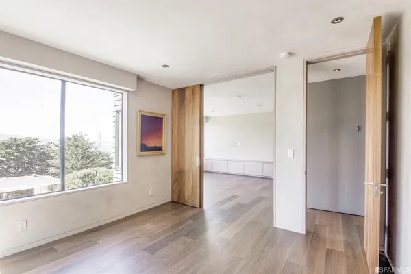 a kitchen with a sink and a large mirror