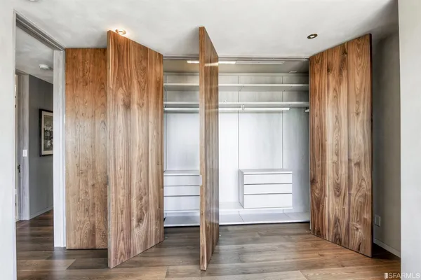 a dining hall with stainless steel appliances granite countertop a stove and chairs with the wooden floor