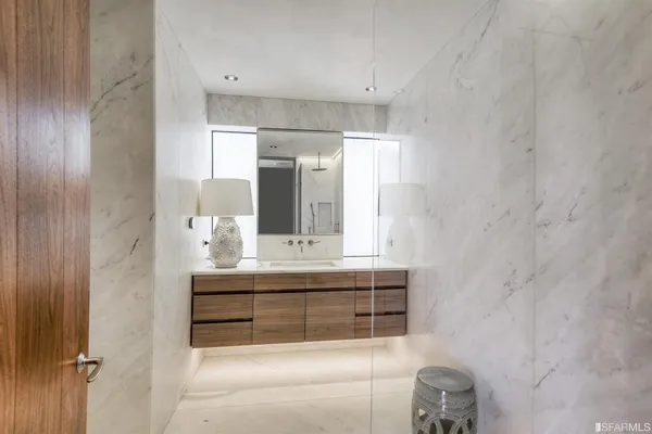 a front view of a house with a yard and a wooden fence