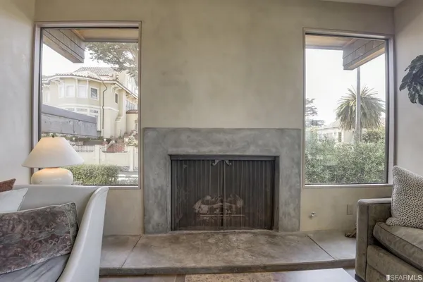 a bedroom with furniture and a large window