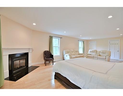 46 Meadow Road Bolton, MA 01740 - Photo 13 of 29 a bedroom with a bed and a fireplace