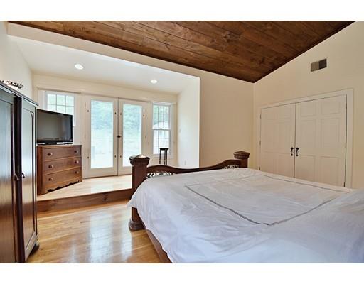 46 Meadow Road Bolton, MA 01740 - Photo 16 of 29 a spacious bedroom with a bed and a flat screen tv
