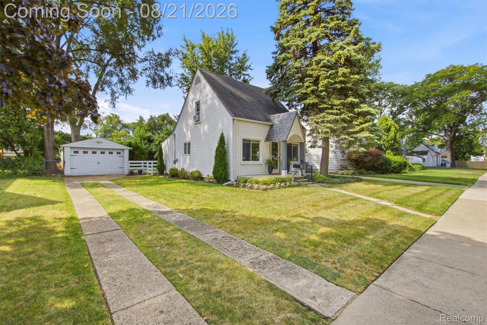 1383 Princeton Road Berkley, MI 48072 - Photo 2 of 28 White siding exterior with a dark roof, covered front entry, established trees, and a detached two-car garage