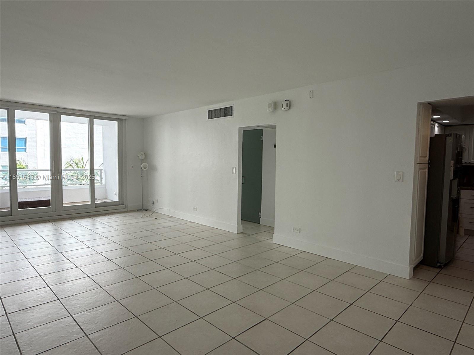5005 Collins Avenue, Unit 823 Miami Beach, FL 33140 - Photo 11 of 34 an empty room with windows