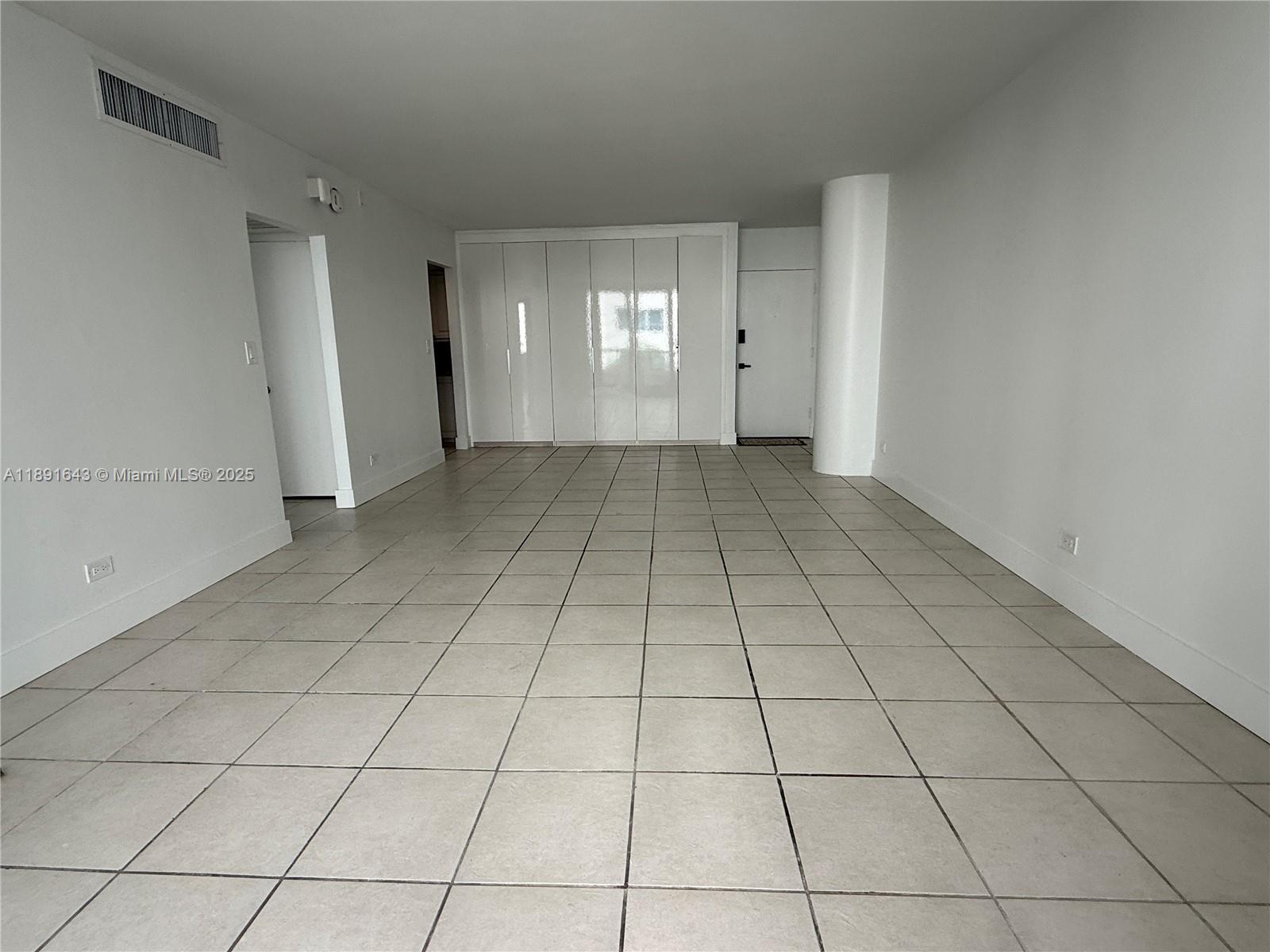 5005 Collins Avenue, Unit 823 Miami Beach, FL 33140 - Photo 12 of 34 a view of an empty room and window