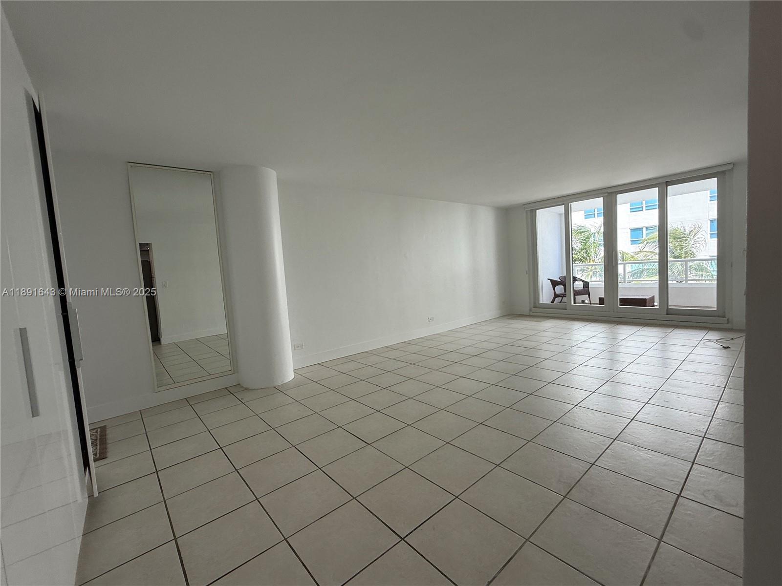 5005 Collins Avenue, Unit 823 Miami Beach, FL 33140 - Photo 13 of 34 an empty room with windows