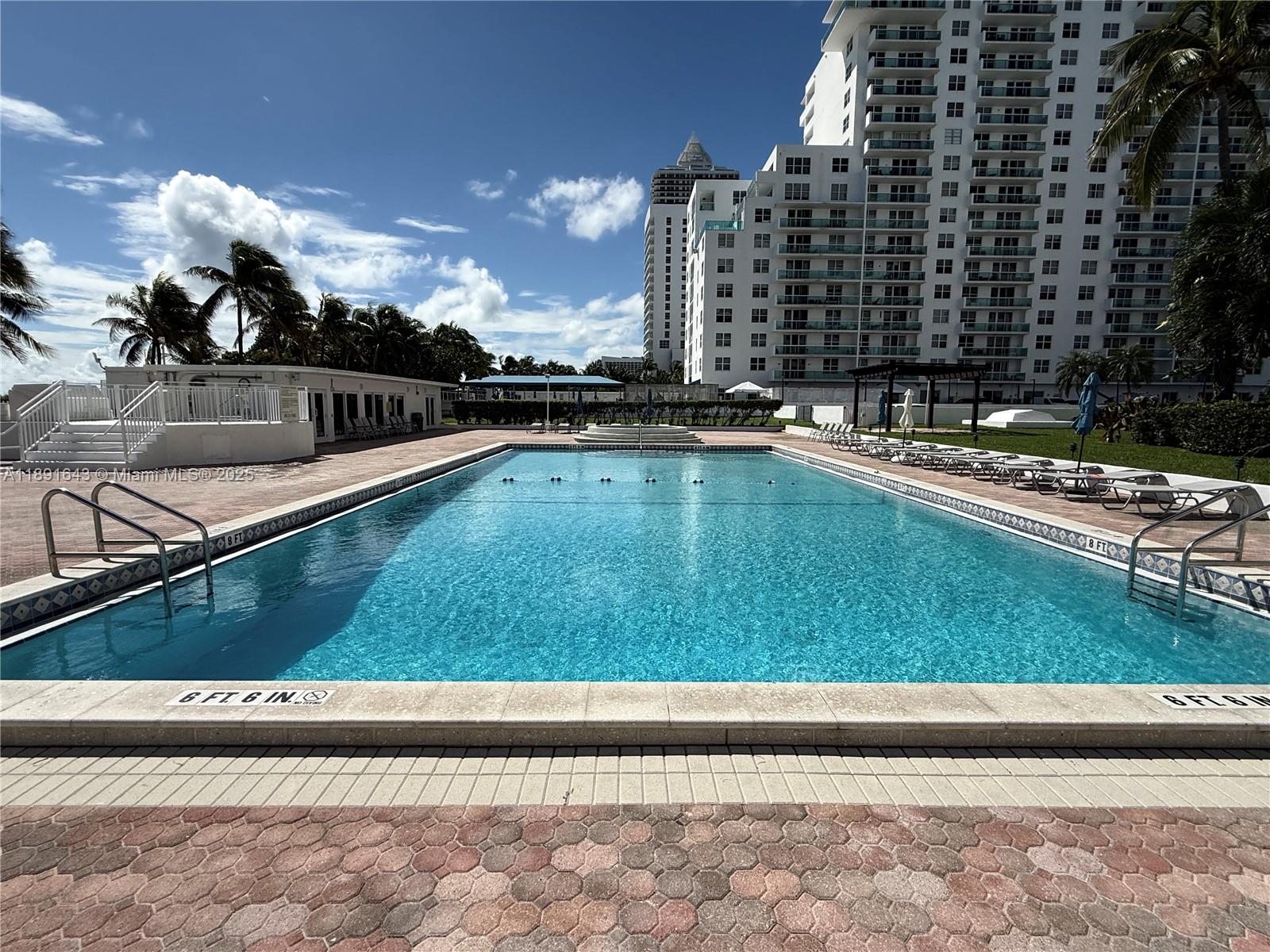 5005 Collins Avenue, Unit 823 Miami Beach, FL 33140 - Photo 23 of 34 a view of swimming pool with a yard