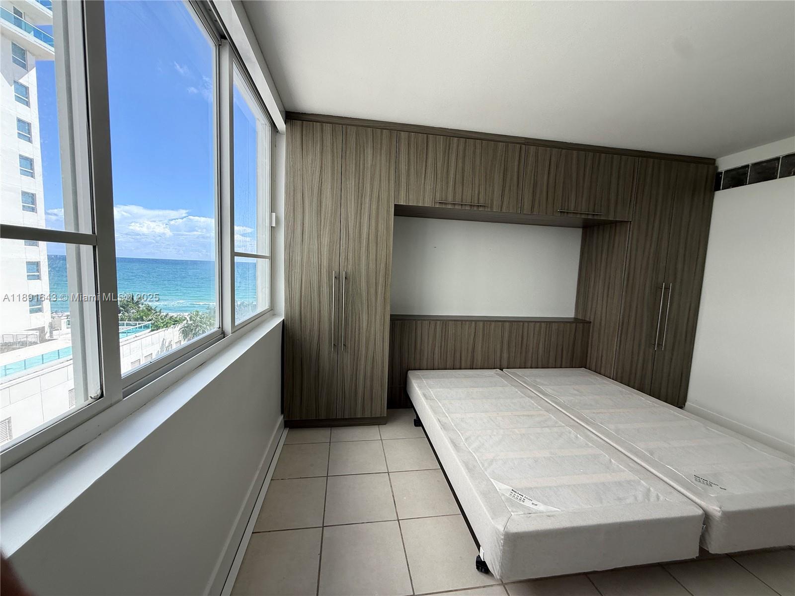 5005 Collins Avenue, Unit 823 Miami Beach, FL 33140 - Photo 25 of 34 a room with a bed and a window