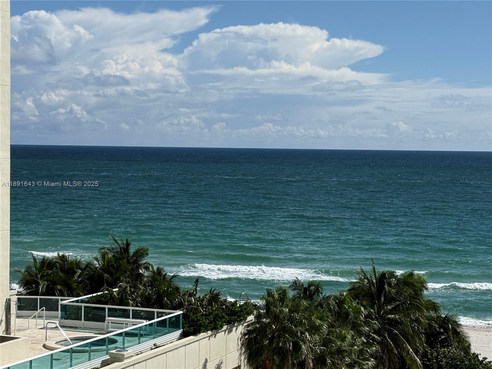 5005 Collins Avenue, Unit 823 Miami Beach, FL 33140 - Photo 4 of 34 a view of a lake from a balcony