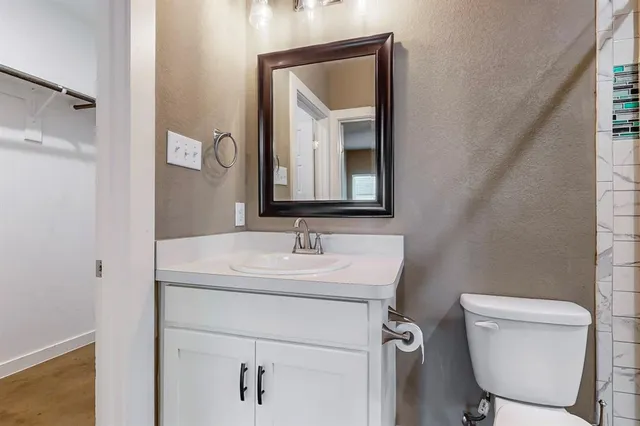 a bathroom with a toilet sink and mirror