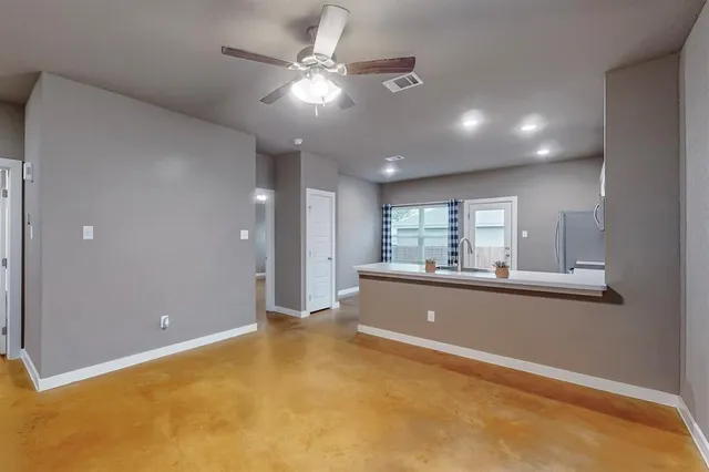 a large white kitchen with a large window