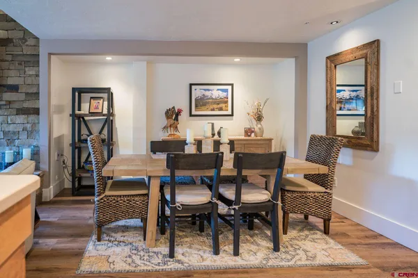 a dining room with a wooden table and chairs