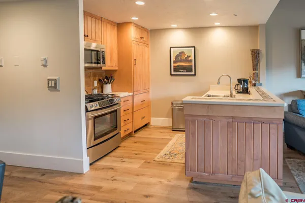 a kitchen with stainless steel appliances granite countertop a stove and a sink