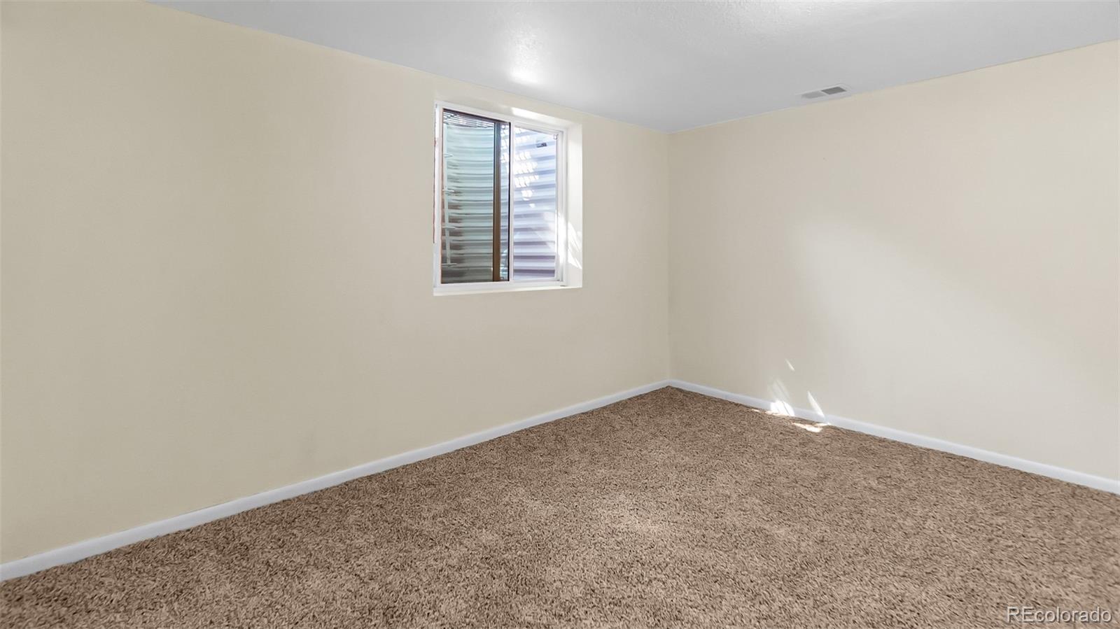 251 West 5th Street Akron, CO 80720 - Photo 20 of 30 an empty room with a window