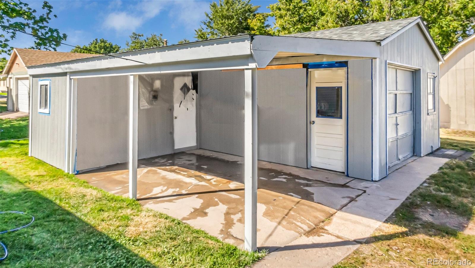 251 West 5th Street Akron, CO 80720 - Photo 25 of 30 a view of a house with backyard and floor to ceiling window