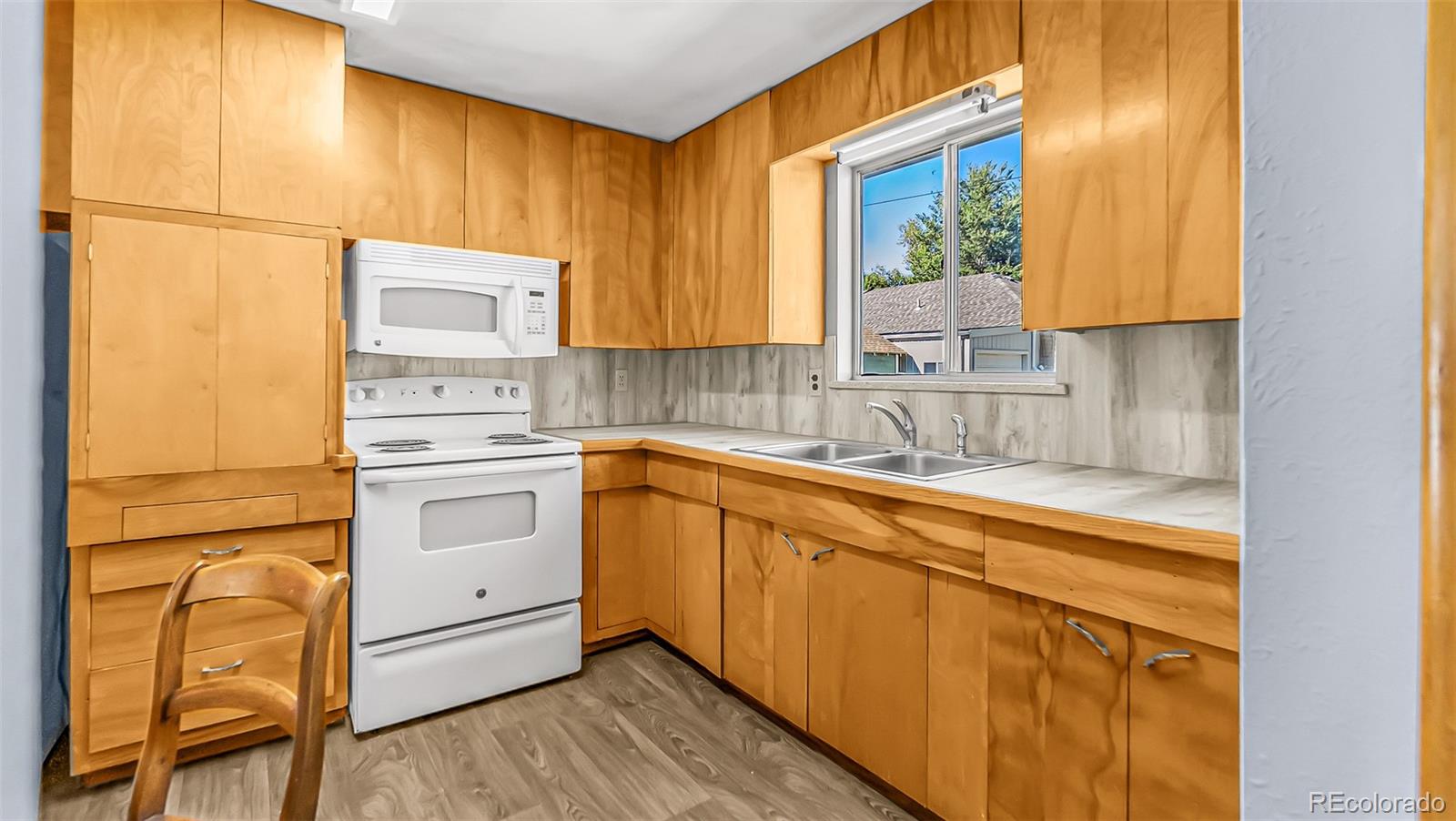251 West 5th Street Akron, CO 80720 - Photo 5 of 30 a kitchen with a sink cabinets and window