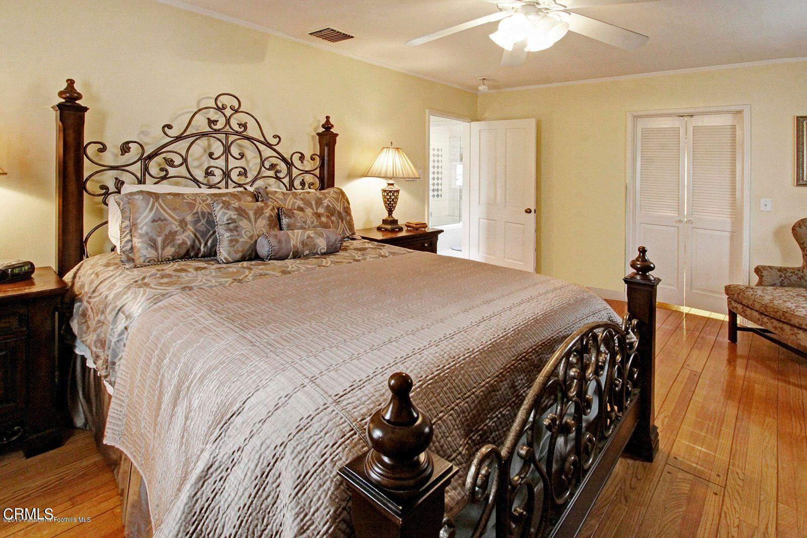 175 Glen Summer Road Pasadena, CA 91105 - Photo 12 of 26 a bedroom with a bed and wooden floor