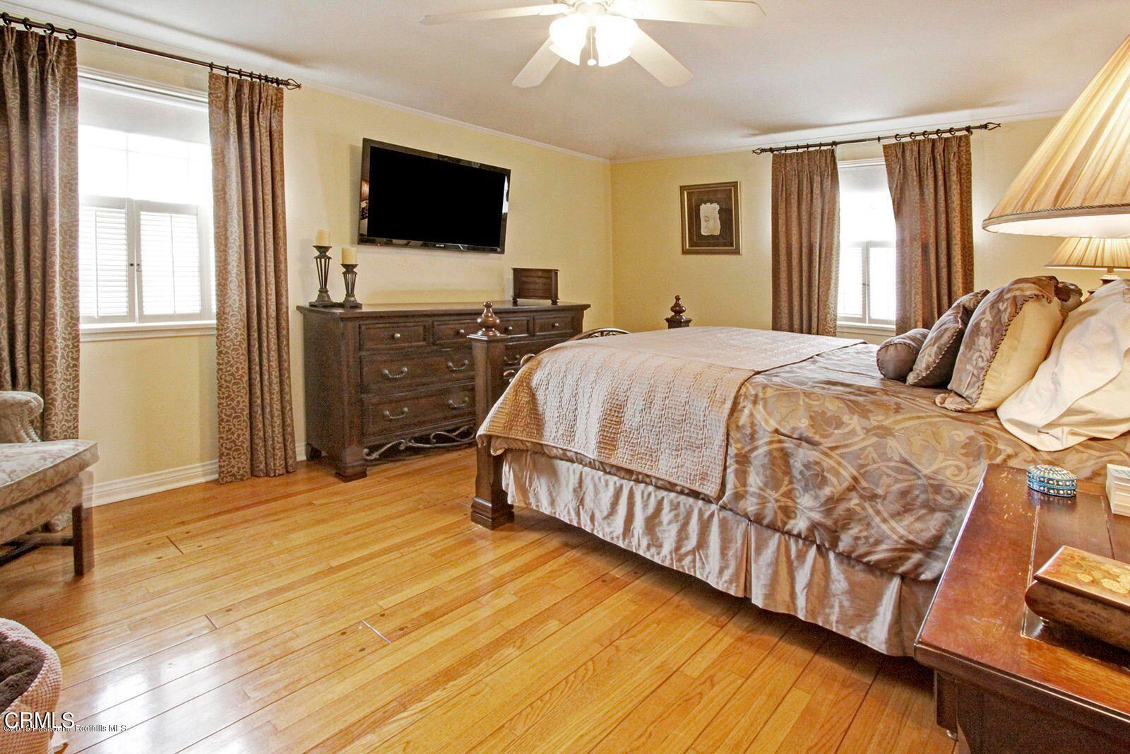 175 Glen Summer Road Pasadena, CA 91105 - Photo 13 of 26 a bedroom with a bed and a flat screen tv