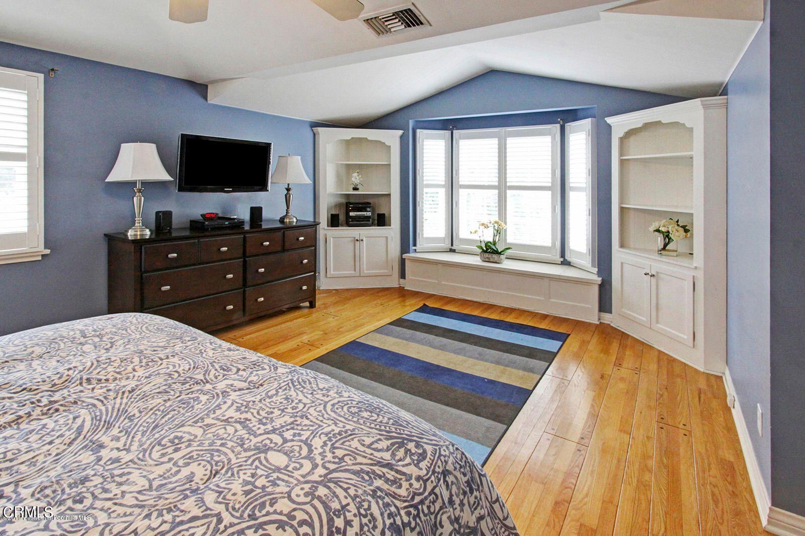 175 Glen Summer Road Pasadena, CA 91105 - Photo 16 of 26 a bedroom with a bed and a flat screen tv