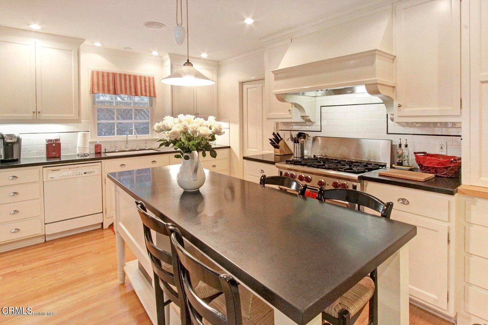 175 Glen Summer Road Pasadena, CA 91105 - Photo 7 of 26 a kitchen with stainless steel appliances granite countertop a sink a stove and a wooden floors