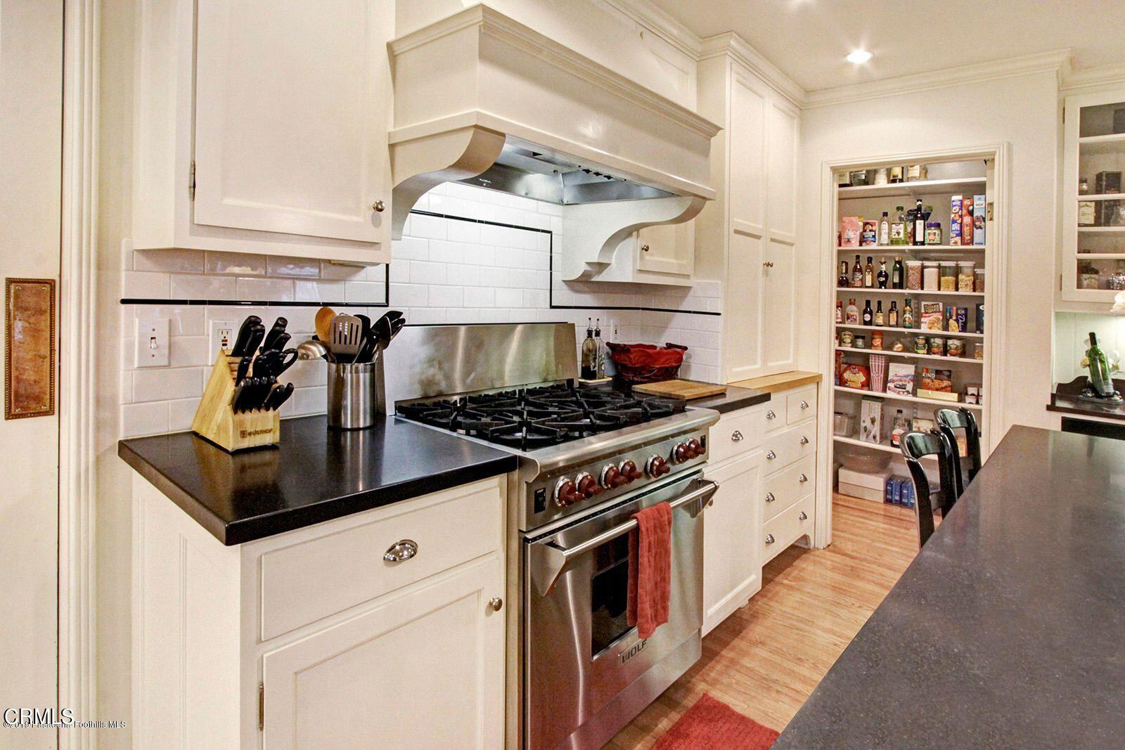 175 Glen Summer Road Pasadena, CA 91105 - Photo 9 of 26 a kitchen with stainless steel appliances a stove and white cabinets