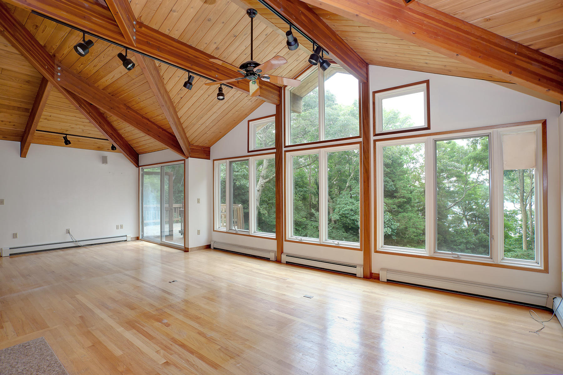 170 Pimlico Pond Road Mashpee, MA 02649 - Photo 11 of 29 a view of an empty room with wooden floor and door