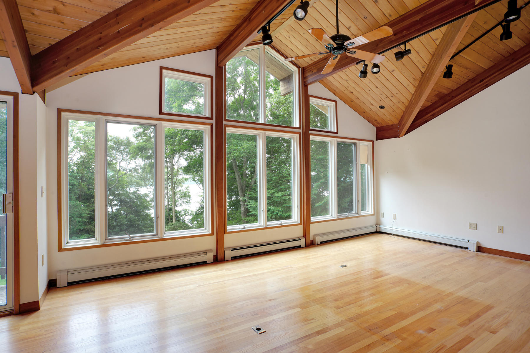 170 Pimlico Pond Road Mashpee, MA 02649 - Photo 12 of 29 an empty room with wooden floor and windows