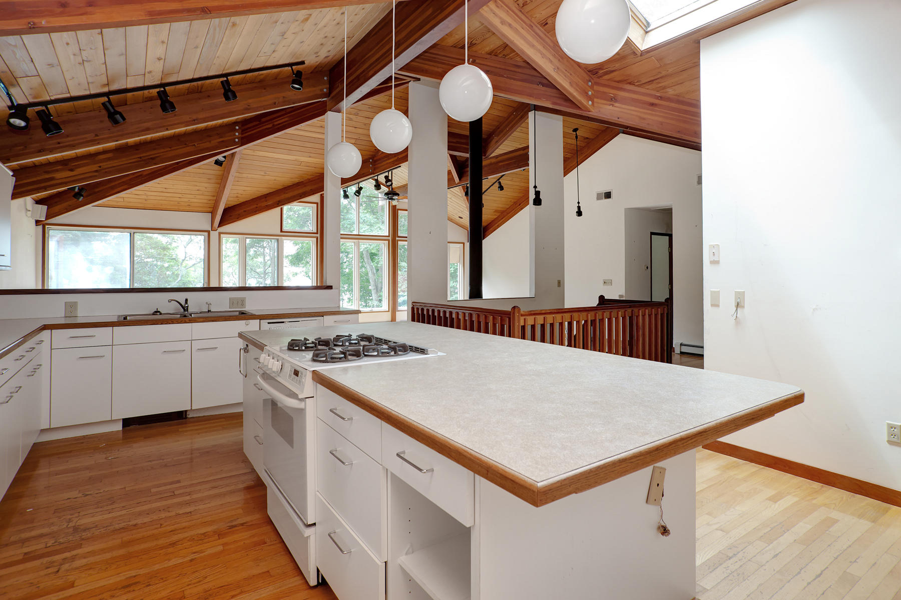 170 Pimlico Pond Road Mashpee, MA 02649 - Photo 6 of 29 a kitchen with a stove a sink dishwasher and a refrigerator with wooden floor