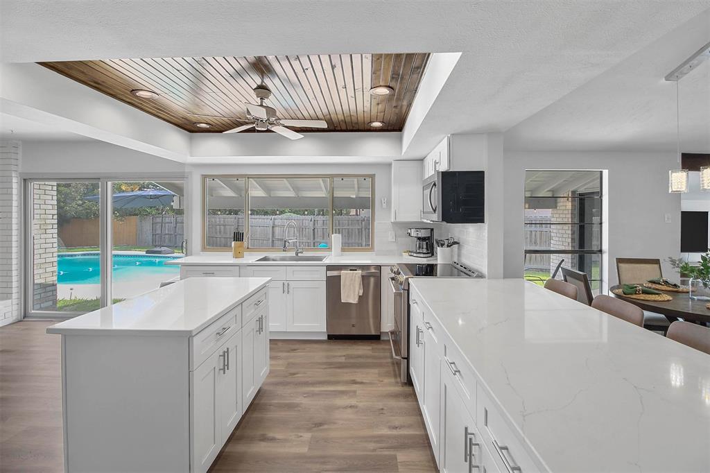 a large white kitchen with a large window