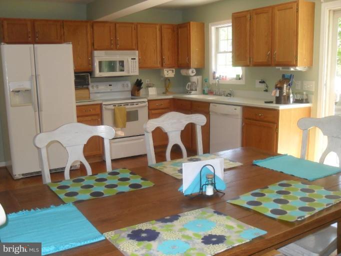 1702 Brookshire Run Point of Rocks, MD 21777 - Photo 3 of 21 a kitchen with stainless steel appliances granite countertop a refrigerator sink and stove