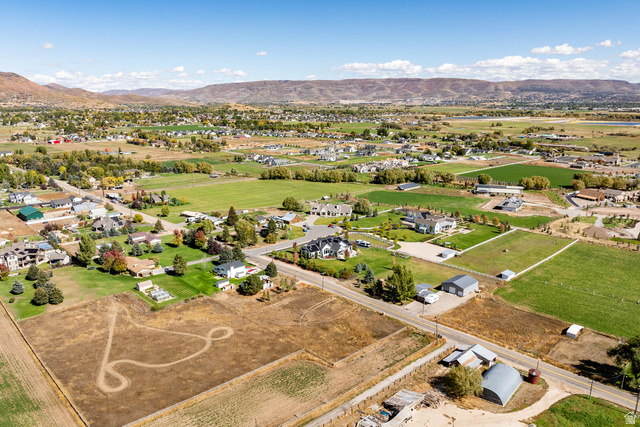 1160 Stringtown Road Midway, UT 84049 - Photo 22 of 26 Aerial view of property's location featuring a mountainous background and nearby suburban area