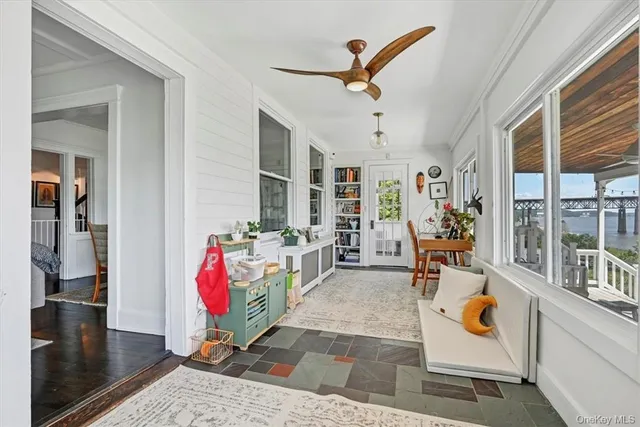 a living room with patio furniture and a wooden floor