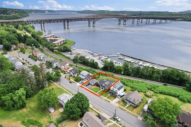 an aerial view of a house with a garden and lake view