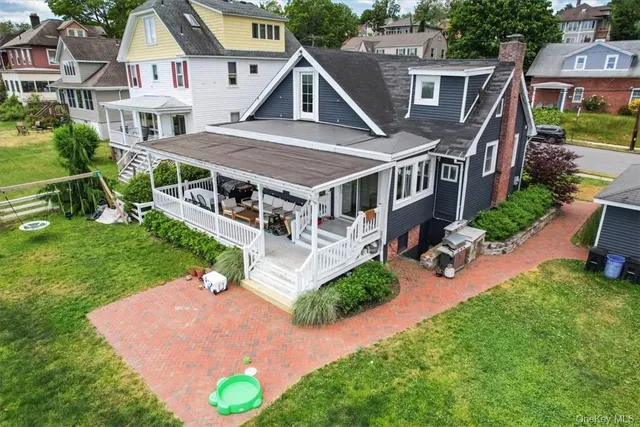 an aerial view of a house with a yard