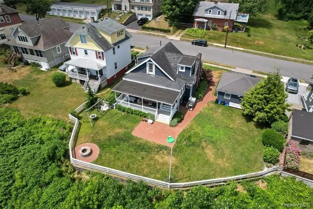 an aerial view of a house with a garden and trees