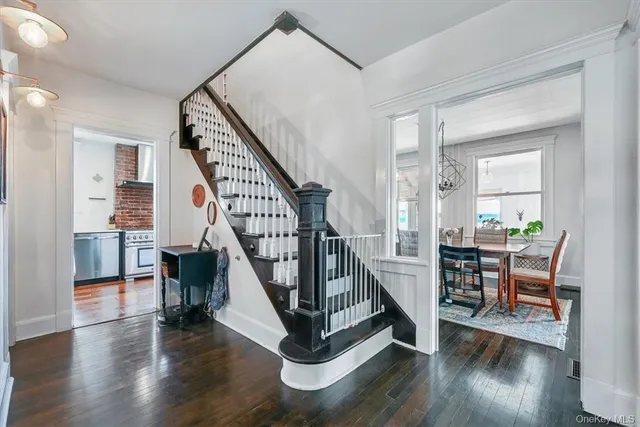 a view of entryway livingroom and hall with wooden floor