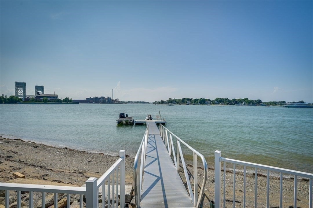 a view of swimming pool with a lake from a balcony