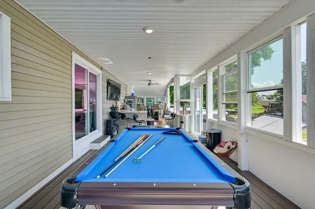 a kitchen with a sink dishwasher a stove and white cabinets with wooden floor