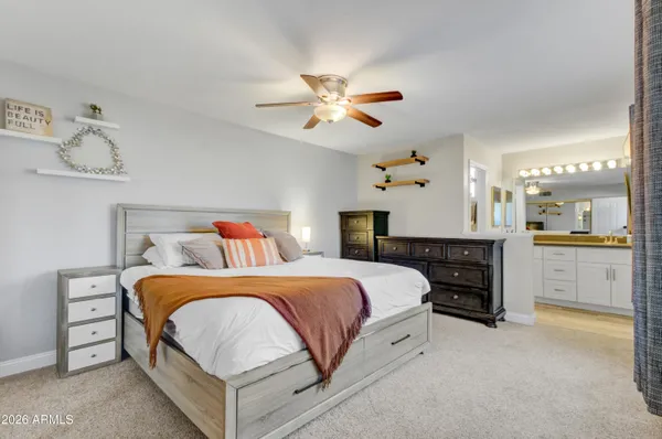 a bedroom with a large bed and a chandelier