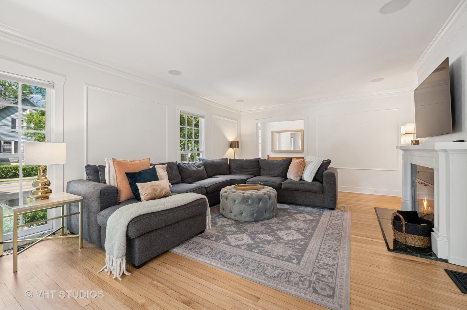 720 Willow Road Winnetka, IL 60093 - Photo 2 of 28 a living room with furniture a fireplace and a flat screen tv